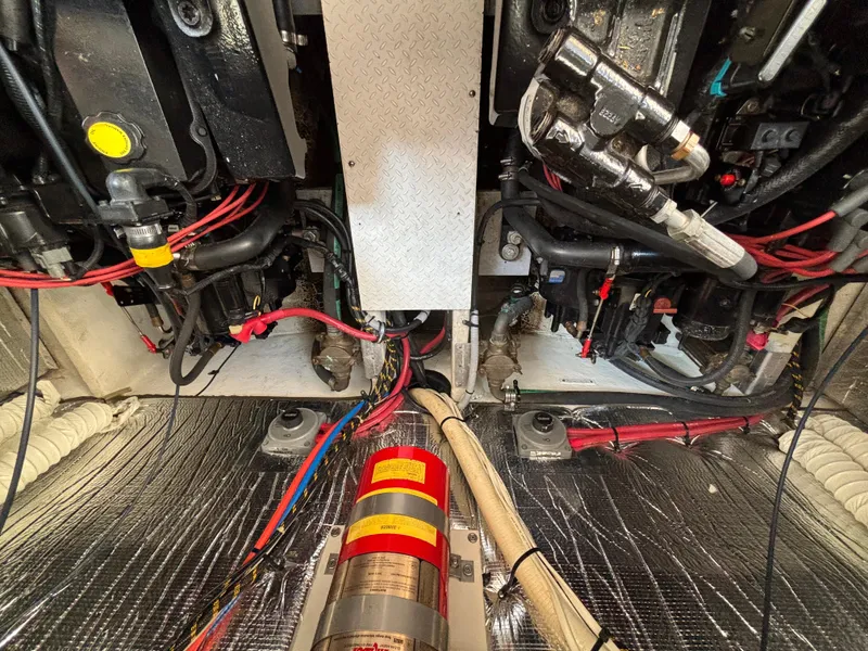 Slide: The Image of Engine room of 2000 Cruisers Yachts 3870 Express with visible wiring and components. - 66