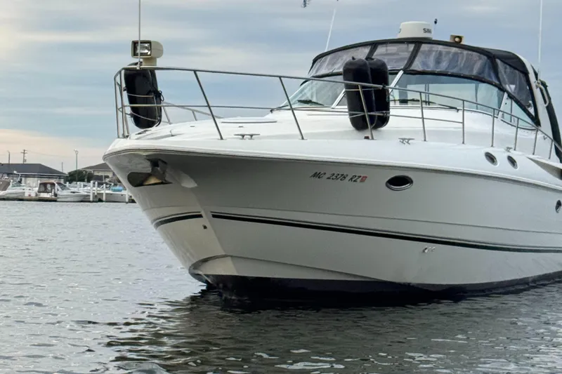 Slide: The Image of 2000 Cruisers Yachts 3870 Express docked in a marina, front view. - 9