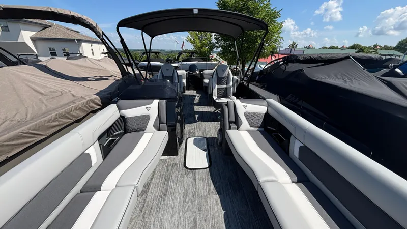 Slide: The Image of 2025 Viaggio Diamante D26U boat interior with sleek seating and canopy under a sunny sky. - 6