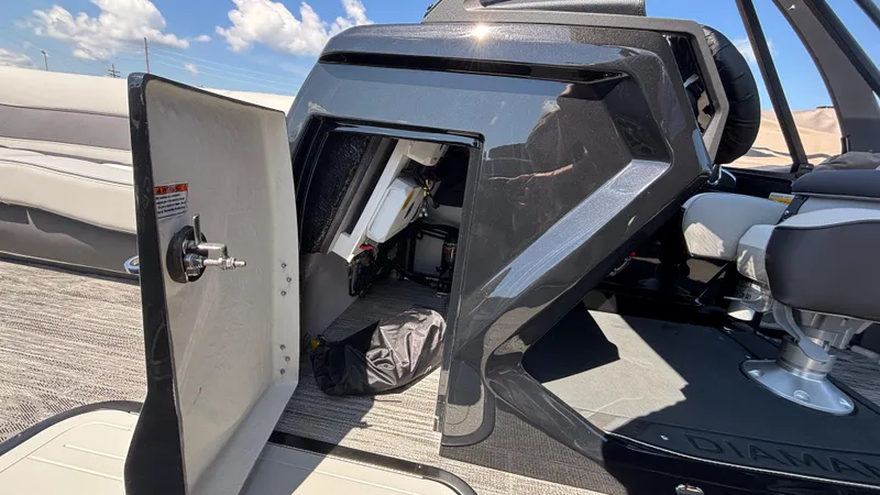 Slide: The Image of Open storage compartment on Viaggio Diamante D26U boat, 2025 model, with seating and clear sky. - 9