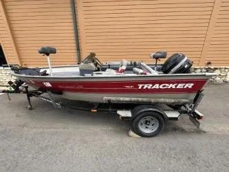 Slide: The Image of 2002 Tracker Pro Guide V-16 SC boat on trailer, red and silver design. - 4