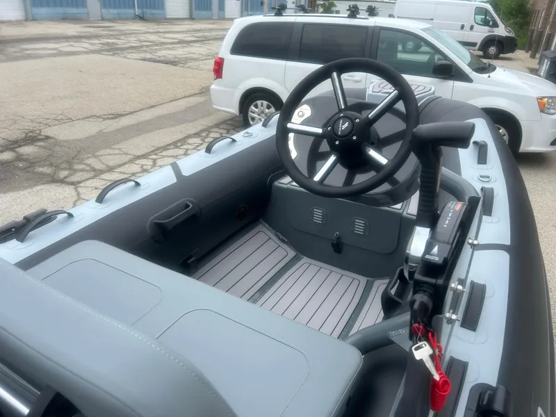 Slide: The Image of 2025 Highfield Classic 310 FCT boat interior with steering wheel and controls. - 11