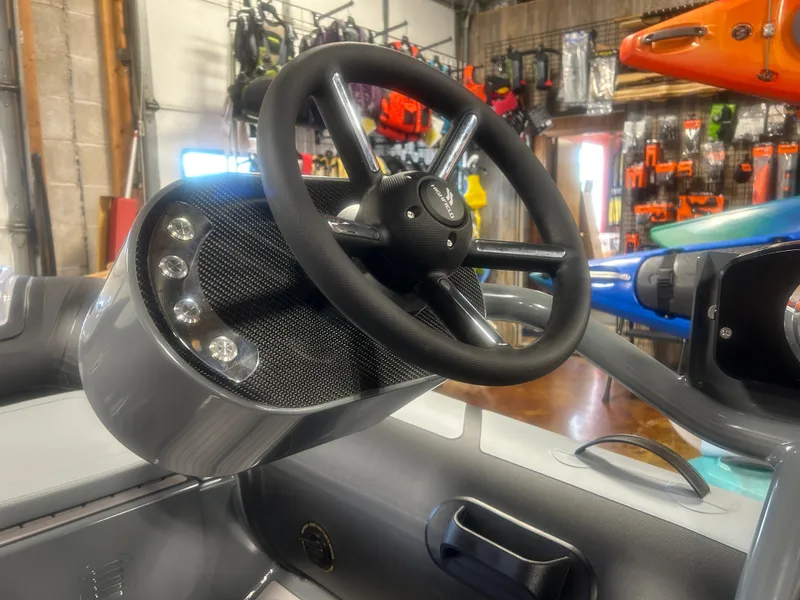 Slide: The Image of Steering wheel of 2025 Highfield Classic 310 FCT boat in showroom setting. - 4