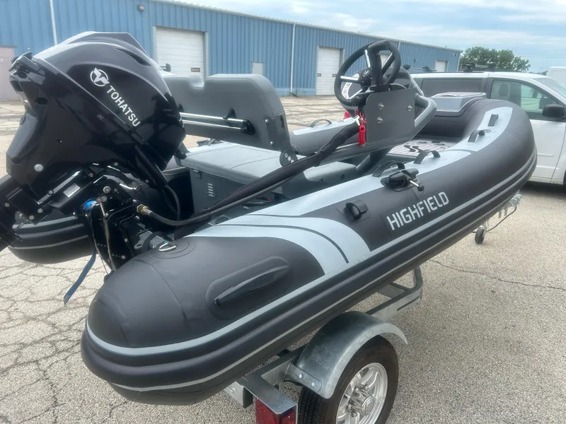 Slide: The Image of 2025 Highfield Classic 310 FCT boat with Tohatsu engine on trailer. - 12