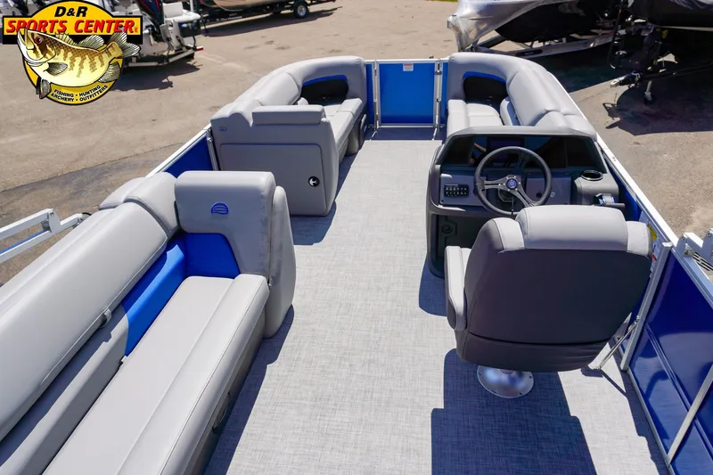 Slide: The Image of 2026 Sun Tracker Party Barge 20 DLX interior with gray seating and steering console. - 3