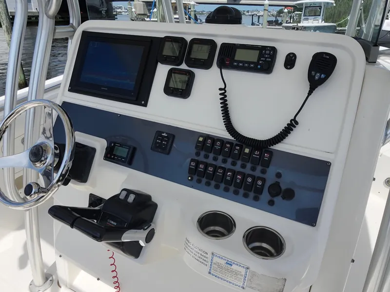 Slide: The Image of 2008 Robalo R300 Center Console boat dashboard with steering wheel and control panel. - 10