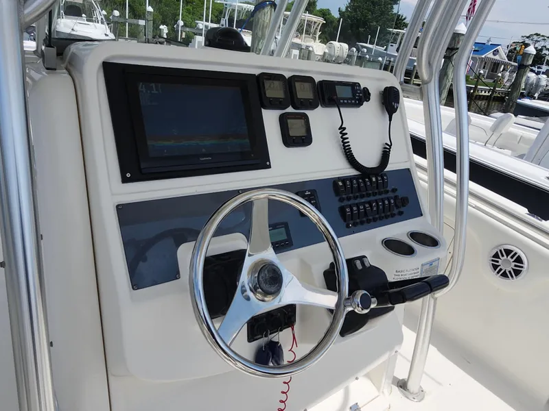 Slide: The Image of 2008 Robalo R300 Center Console dashboard with steering wheel and navigation controls. - 11