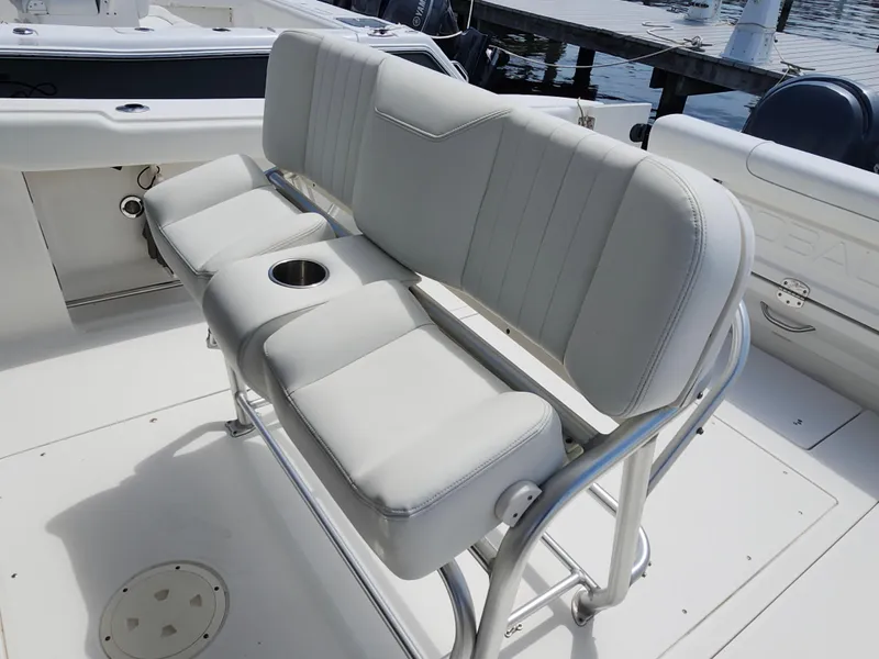 Slide: The Image of 2008 Robalo R300 Center Console boat with cushioned seating and cup holder. - 15