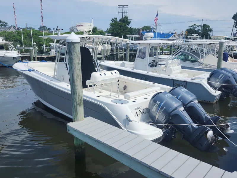 Slide: The Image of 2008 Robalo R300 Center Console boat docked with twin Yamaha engines. - 2