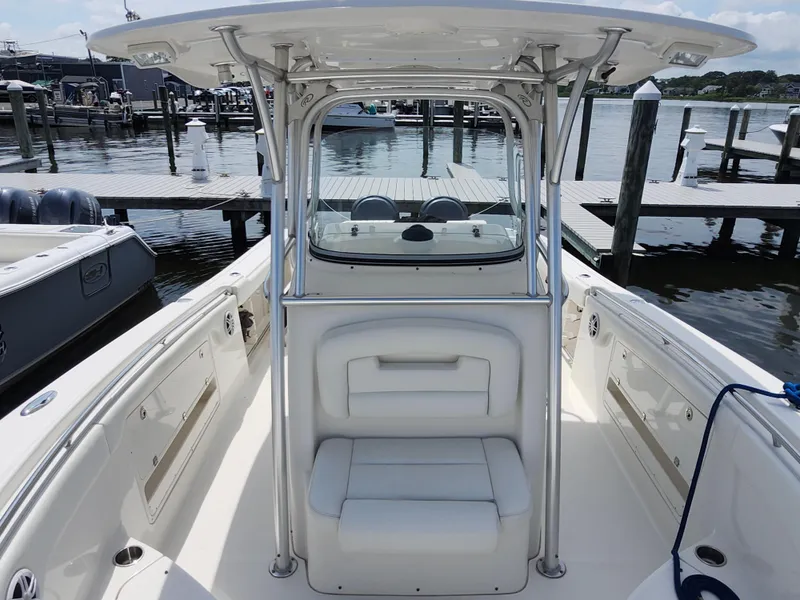Slide: The Image of 2008 Robalo R300 Center Console boat docked at marina, showcasing seating and console area. - 21