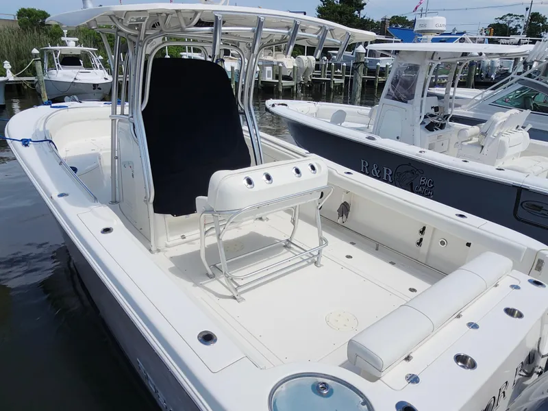 Slide: The Image of 2008 Robalo R300 Center Console boat docked, featuring spacious deck and seating. - 22
