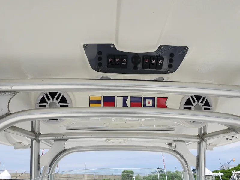Slide: The Image of 2008 Robalo R300 Center Console boat interior with control panel and nautical flags. - 28