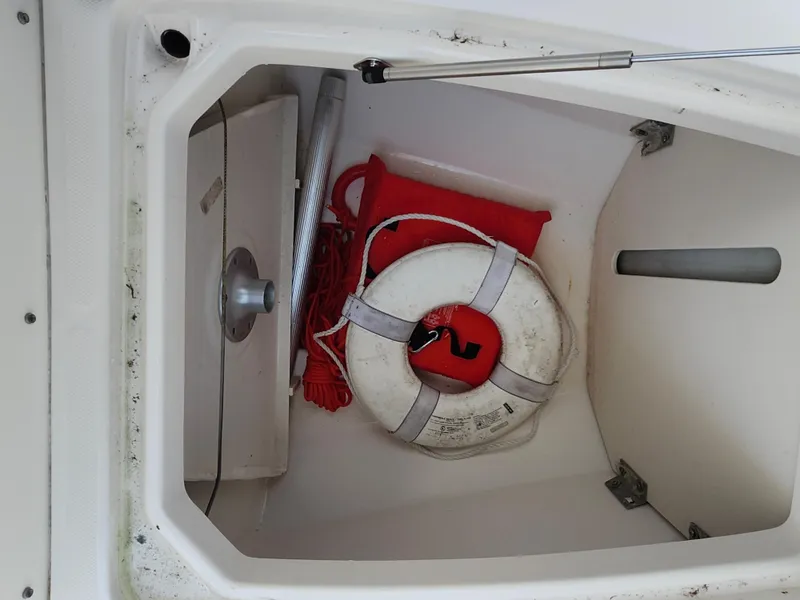 Slide: The Image of Storage compartment of 2008 Robalo R300 Center Console with life preserver and safety equipment. - 30