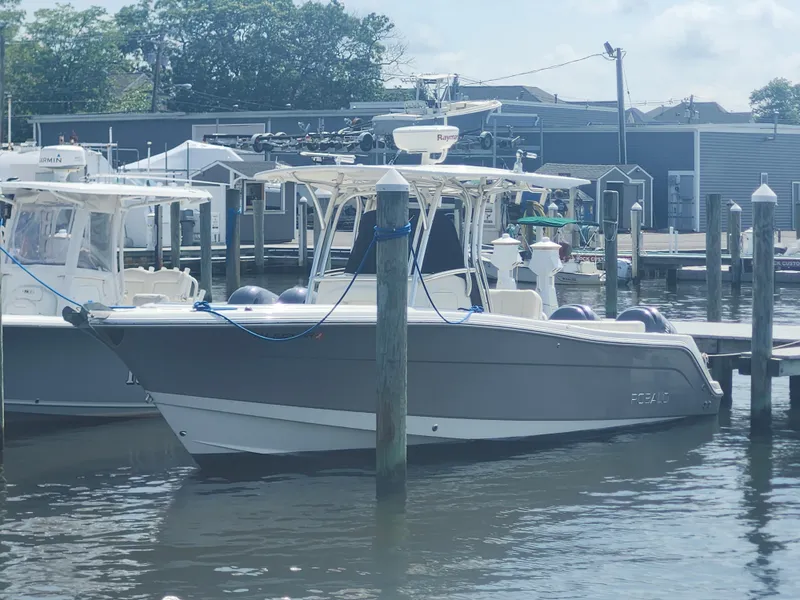 Slide: The Image of 2008 Robalo R300 Center Console boat docked at a marina on a sunny day. - 8