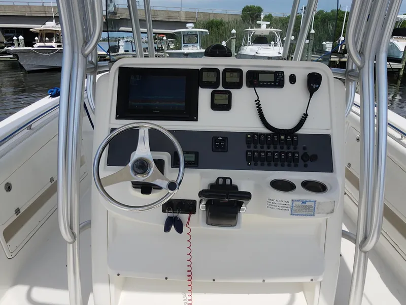 Slide: The Image of 2008 Robalo R300 Center Console boat dashboard with steering wheel and navigation controls. - 9