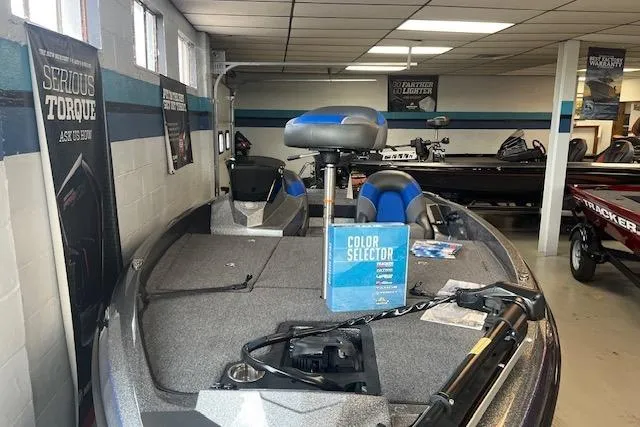 Slide: The Image of 2025 Ranger Z185 boat in showroom, featuring blue and gray interior with color selector display. - 72