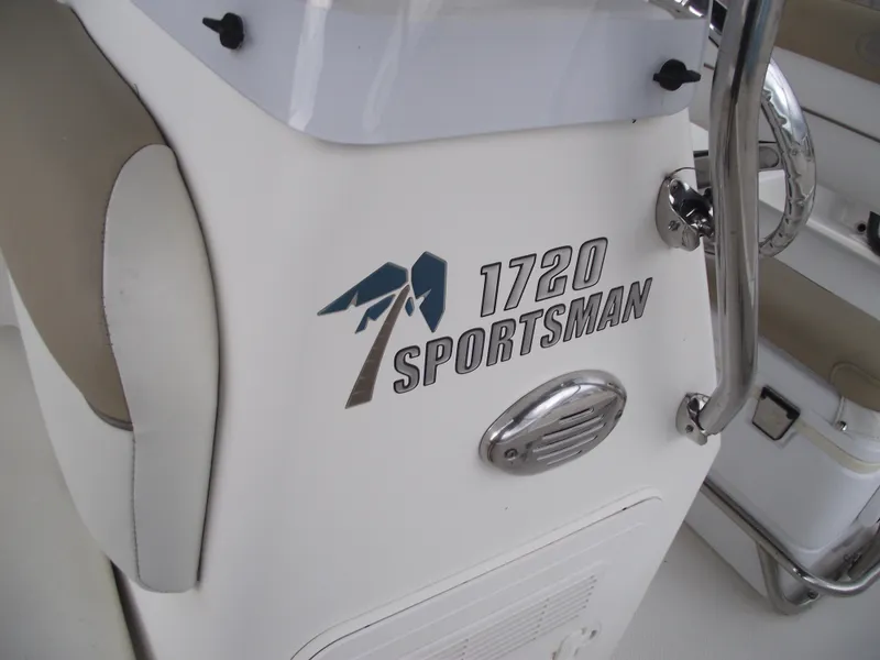 Slide: The Image of 2016 Key West 1720 Center Console boat interior with "Sportsman" logo and chrome details. - 15