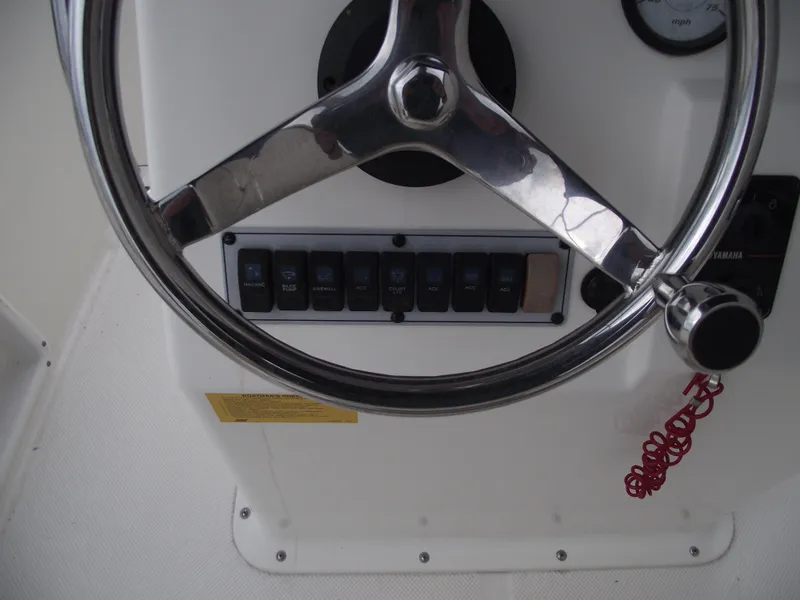 Slide: The Image of Steering wheel and controls of a 2016 Key West 1720 Center Console boat. - 16