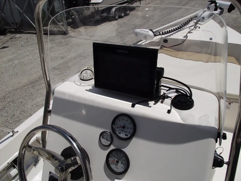 Slide: The Image of 2016 Key West 1720 Center Console boat dashboard with steering wheel and navigation equipment. - 18