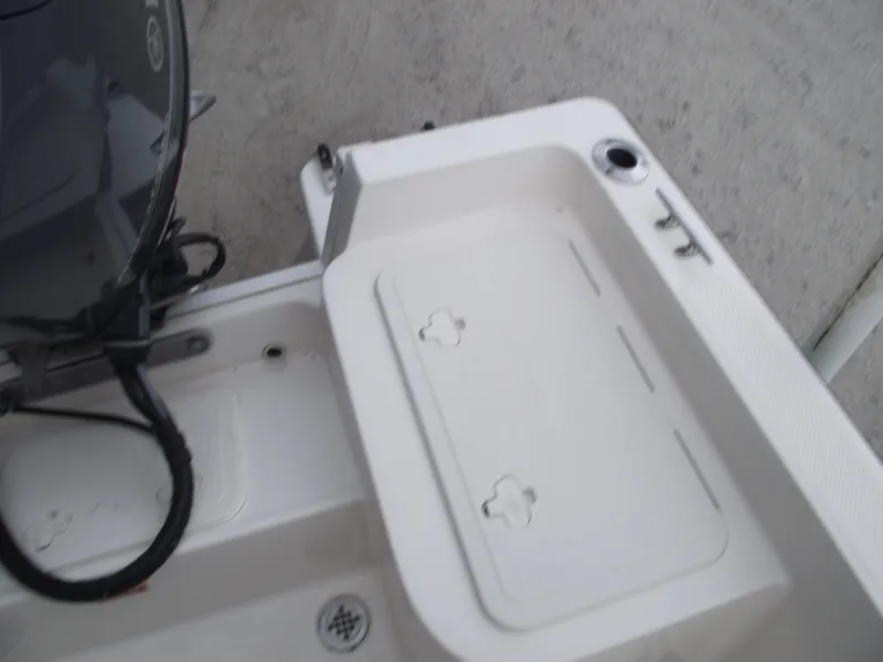 Slide: The Image of 2016 Key West 1720 Center Console boat deck with storage compartment and motor. - 26
