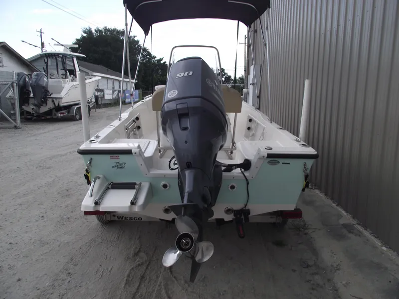 Slide: The Image of 2016 Key West 1720 Center Console boat with Yamaha 90 engine, parked outdoors. - 3