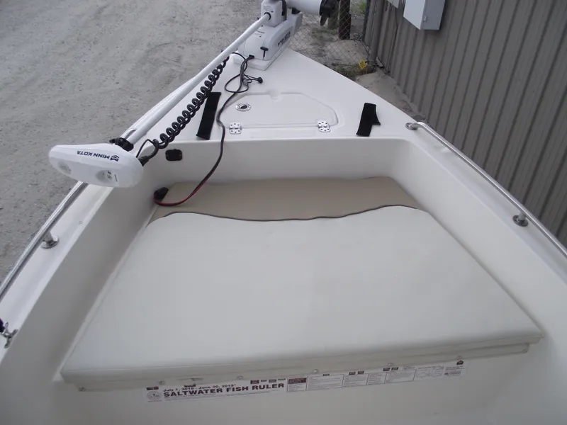 Slide: The Image of 2016 Key West 1720 Center Console boat with Minn Kota trolling motor and cushioned seating. - 6