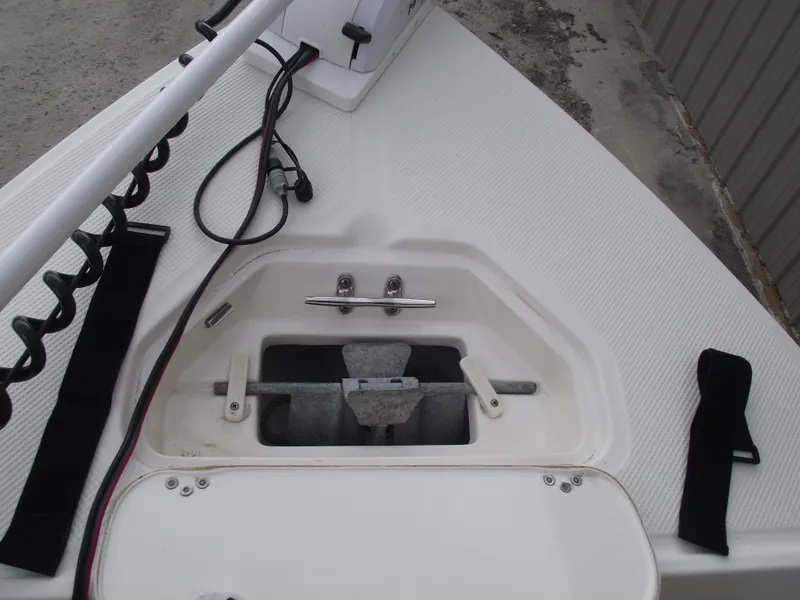 Slide: The Image of 2016 Key West 1720 Center Console boat anchor compartment with wiring and accessories. - 9