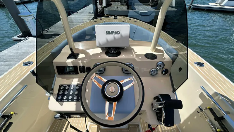 Slide: The Image of 2025 Lilybaeum Levenzo boat dashboard with steering wheel and navigation controls. - 12
