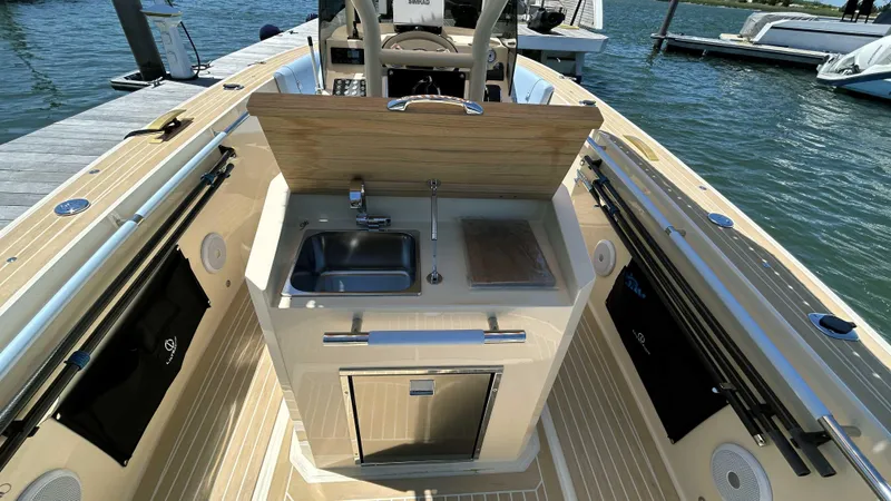 Slide: The Image of 2025 Lilybaeum Levenzo boat interior with sink and storage, docked by the water. - 18