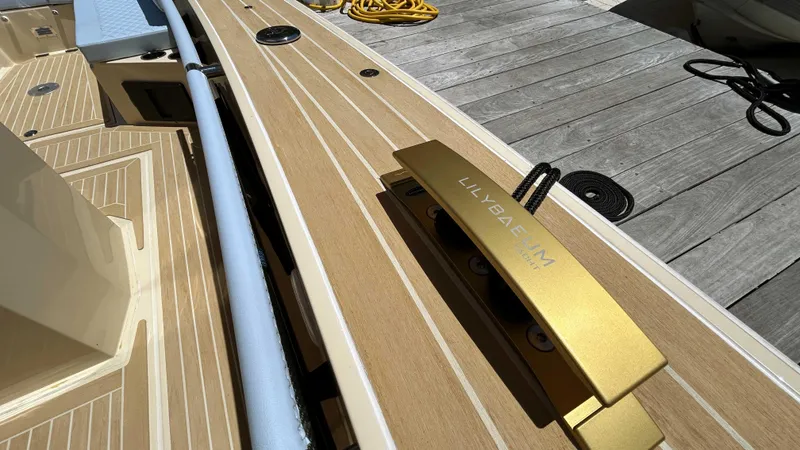 Slide: The Image of 2025 Lilybaeum Levenzo boat deck with gold cleat and wooden finish. - 21