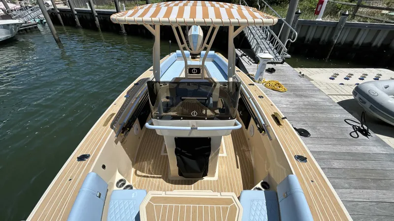 Slide: The Image of 2025 Lilybaeum Levenzo boat docked, featuring striped canopy and spacious seating. - 25