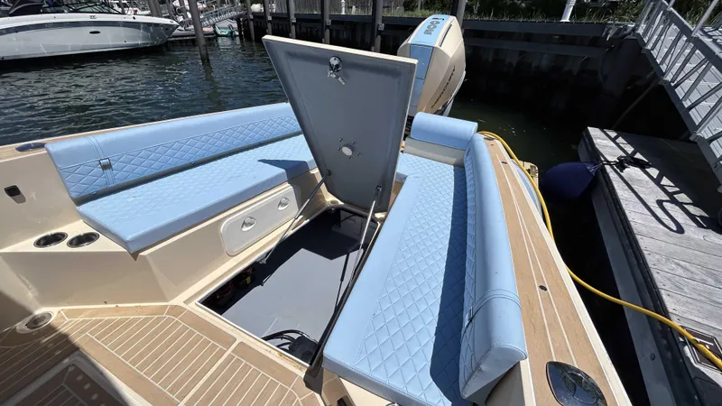Slide: The Image of 2025 Lilybaeum Levenzo boat interior with blue seating and open storage compartment. - 26