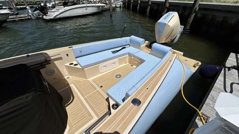 Slide: The Image of 2025 Lilybaeum Levenzo boat with blue seating, docked by the water. - 4