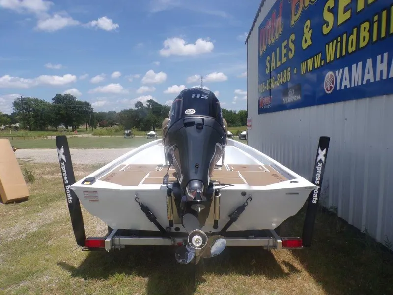 Slide: The Image of 2026 Xpress XP20CC boat with Yamaha engine at dealership, rear view. - 1