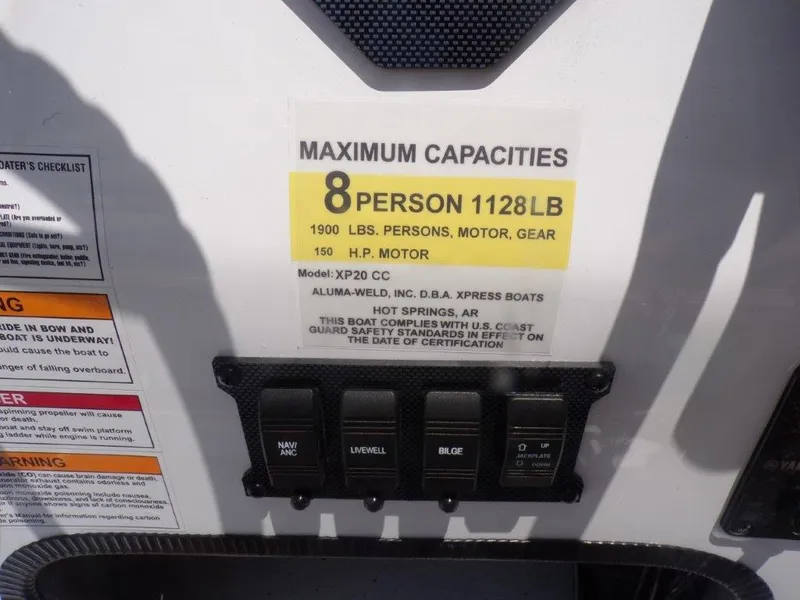 Slide: The Image of 2026 Xpress XP20CC boat capacity label, 8 persons, 1128 lbs, 150 HP motor. - 2