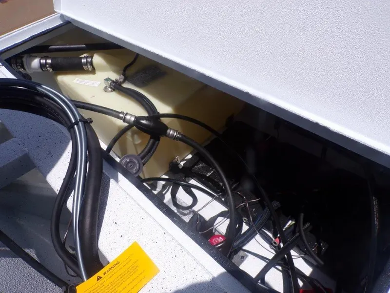 Slide: The Image of 2026 Xpress XP20CC boat compartment with cables and fuel tank. - 23