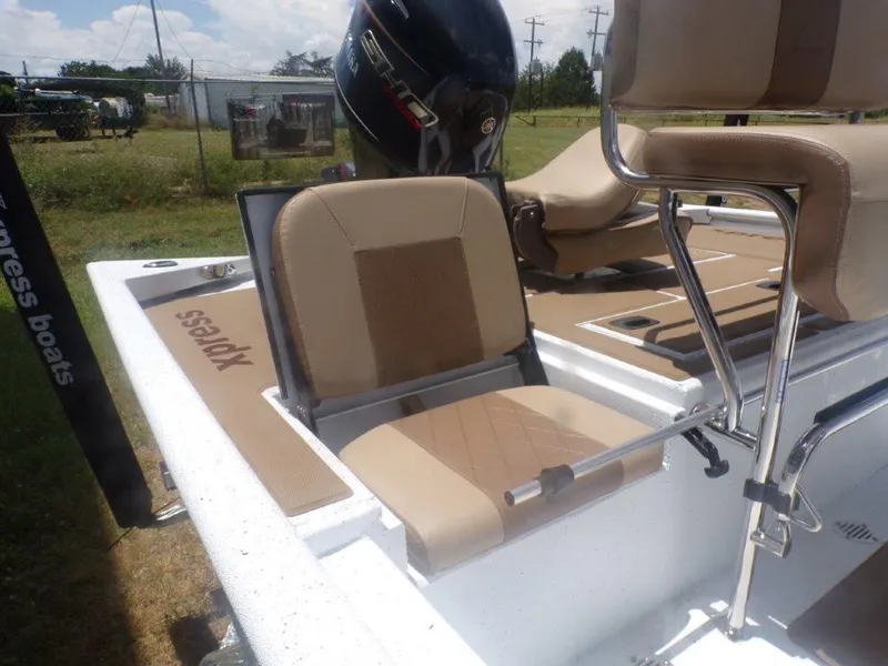 Slide: The Image of 2026 Xpress XP20CC boat with tan seating and Yamaha outboard motor. - 24