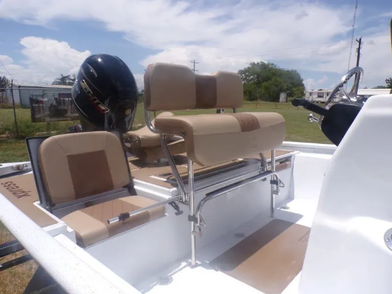Slide: The Image of 2026 Xpress XP20CC boat interior with beige seating and outboard motor. - 4
