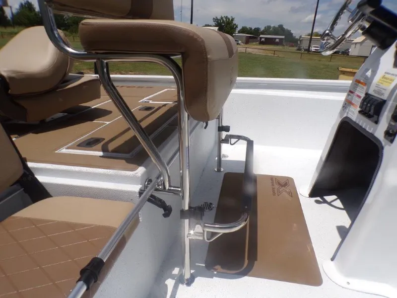 Slide: The Image of 2026 Xpress XP20CC boat interior with tan seating and metal frame. - 5