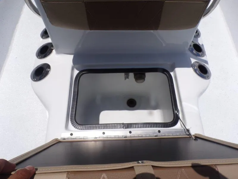 Slide: The Image of Open storage compartment on 2026 Xpress XP20CC boat, featuring multiple rod holders. - 7