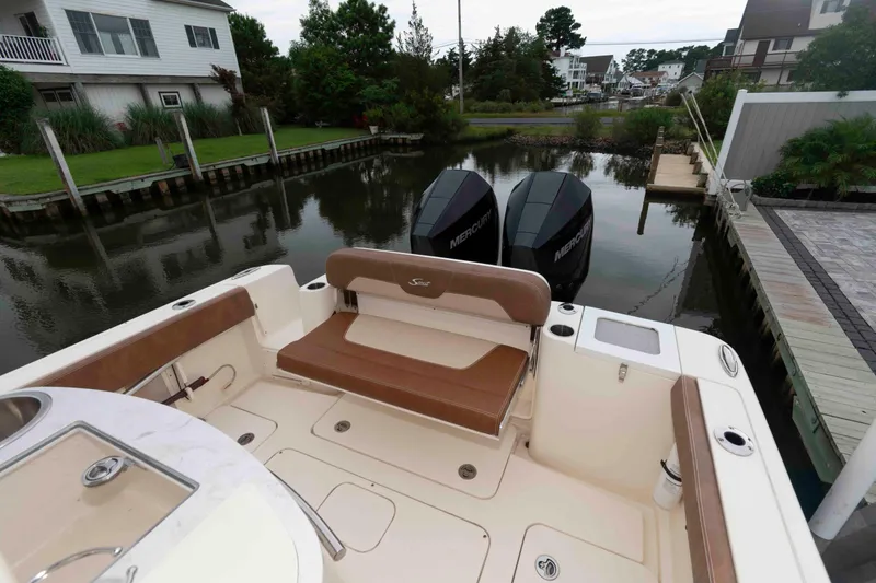 Slide: The Image of 2023 Scout 277 LXF boat docked with dual Mercury engines. - 8
