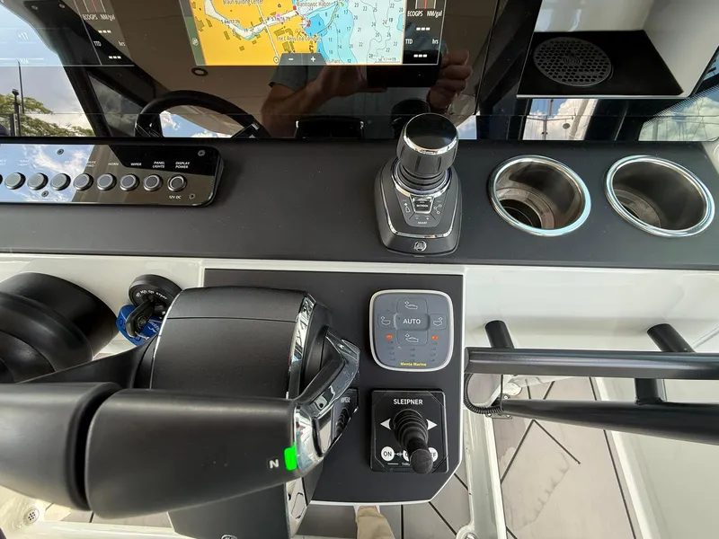 Slide: The Image of Control panel of 2024 Saxdor 320 GTO boat with navigation and joystick controls. - 18