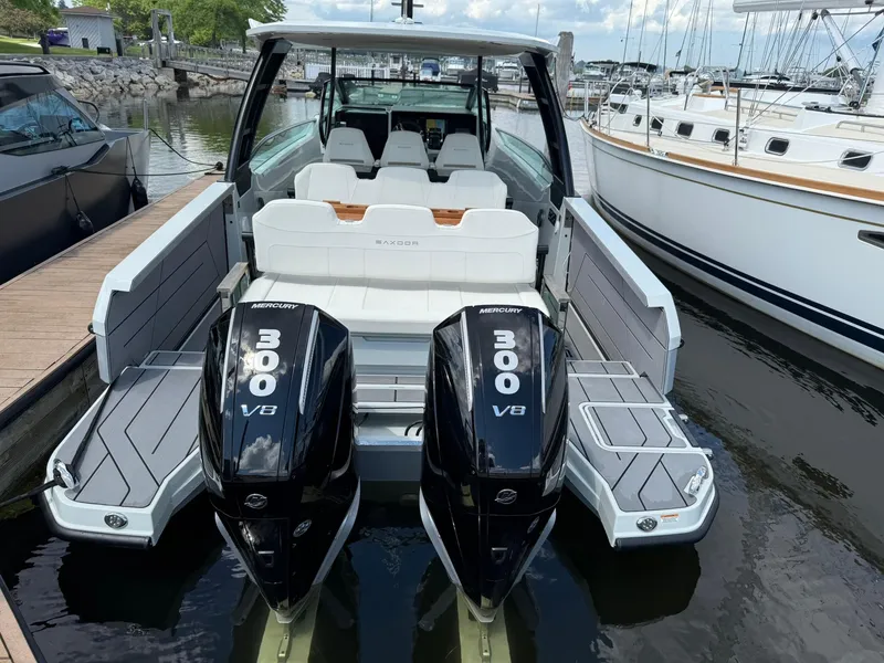 Slide: The Image of 2024 Saxdor 320 GTO with twin Mercury 300 V8 engines docked at marina. - 2