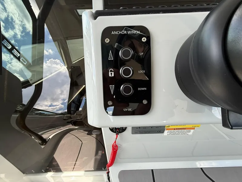 Slide: The Image of 2024 Saxdor 320 GTO anchor winch control panel with reflection of sky. - 20