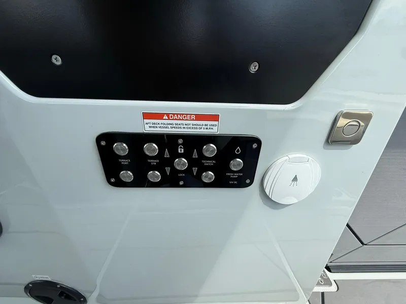 Slide: The Image of Control panel on 2024 Saxdor 320 GTO boat with warning label and buttons. - 21