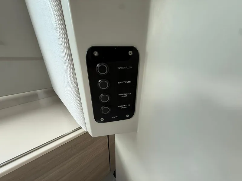 Slide: The Image of Control panel in 2024 Saxdor 320 GTO boat, featuring toilet and water pump buttons. - 25