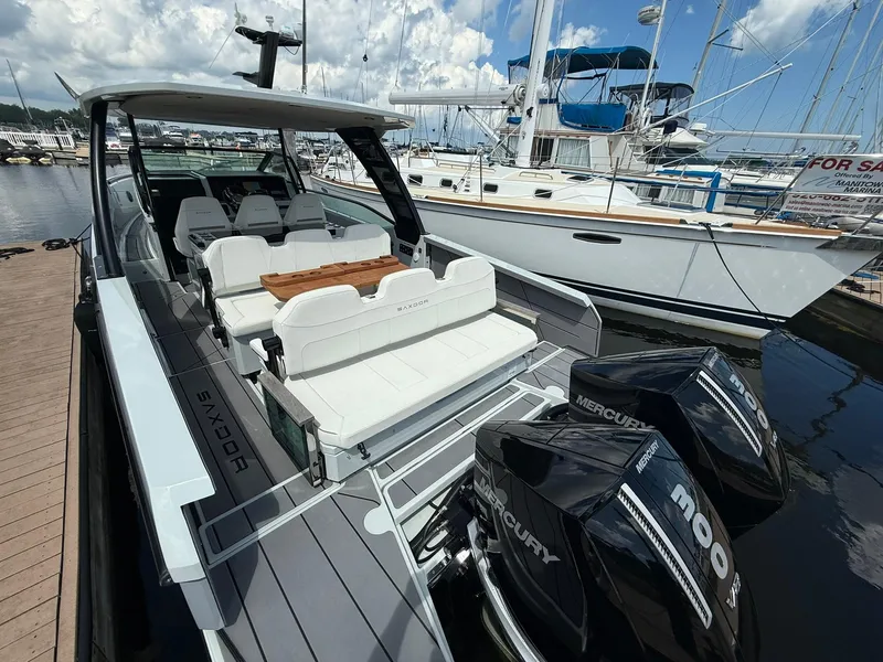 Slide: The Image of 2024 Saxdor 320 GTO boat with twin Mercury engines docked at marina. - 3