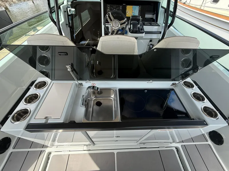 Slide: The Image of 2024 Saxdor 320 GTO boat interior with modern kitchen setup and steering console. - 8