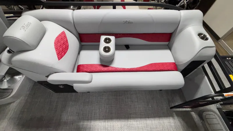 Slide: The Image of Luxurious seating on 2025 JC Neptoon 25TT Sport pontoon boat with red accents and cup holders. - 11