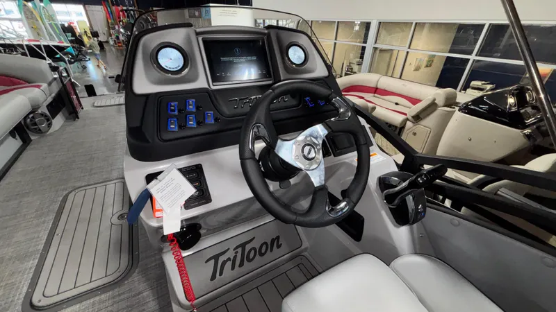 Slide: The Image of 2025 JC Neptoon 25TT Sport boat dashboard with steering wheel and control panel. - 15